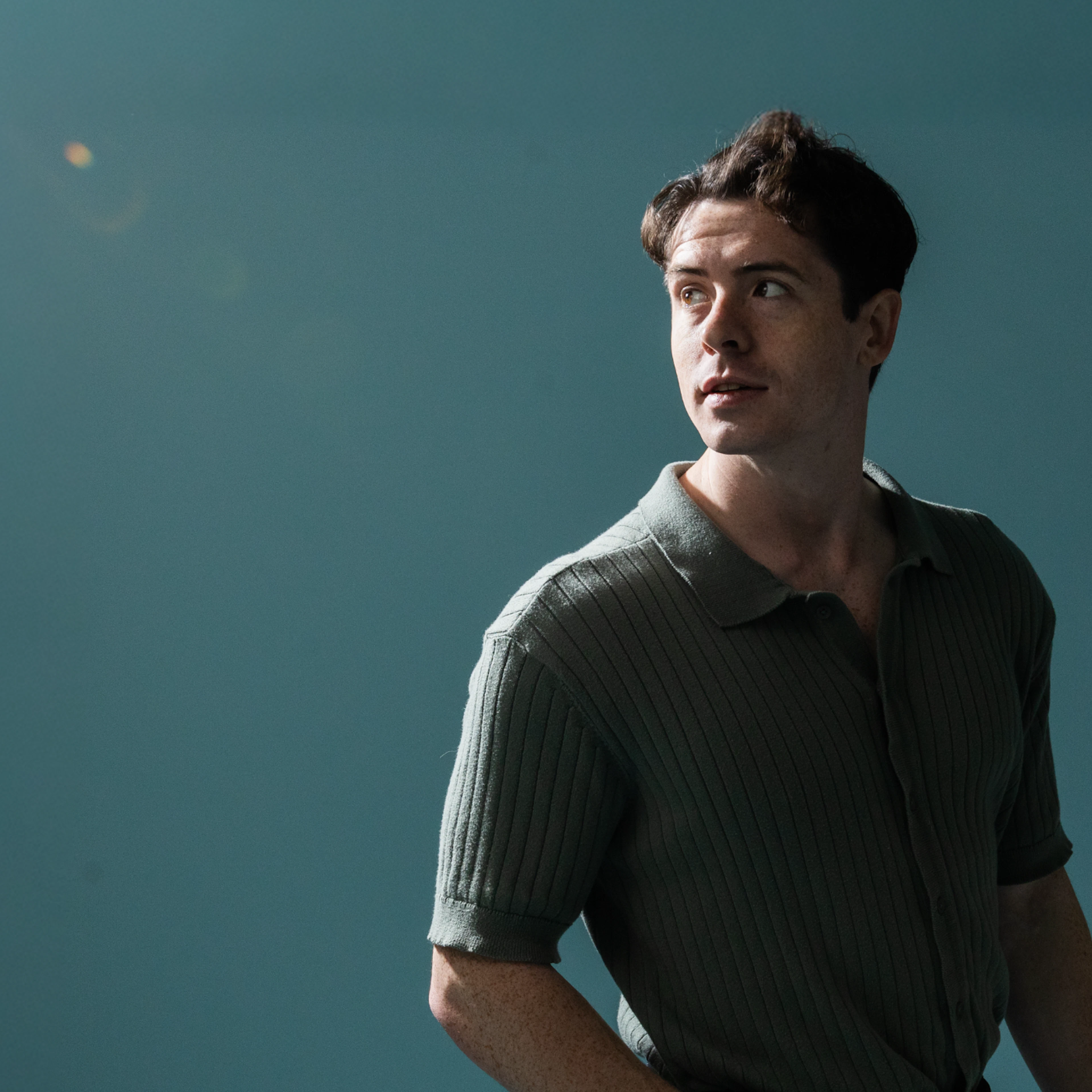 Maxwell Knowles portrait with teal backdrop